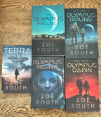 Six paperback books by Zoë Routh arranged on a wooden surface: Terra Blanca Insurrection, The Olympus Project, Gaza Book 2 Olympus Bound, Gaza Book 3 Olympus Rising, Gaza Book 4 Gaza Dawn, and Olympus Dawn. The covers feature space-themed artwork with astronauts, planets, and dramatic sky scenes.