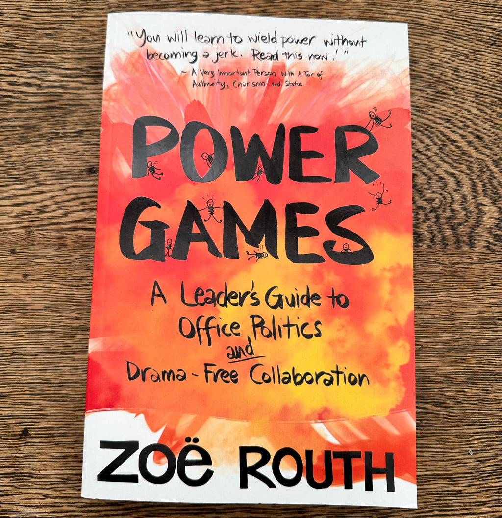 The book cover of 'Power Games: A Leader's Guide to Office Politics and Drama-Free Collaboration' by Zoë Routh, featuring a vibrant orange and red watercolor background with black text, photographed flat on a wooden surface.
