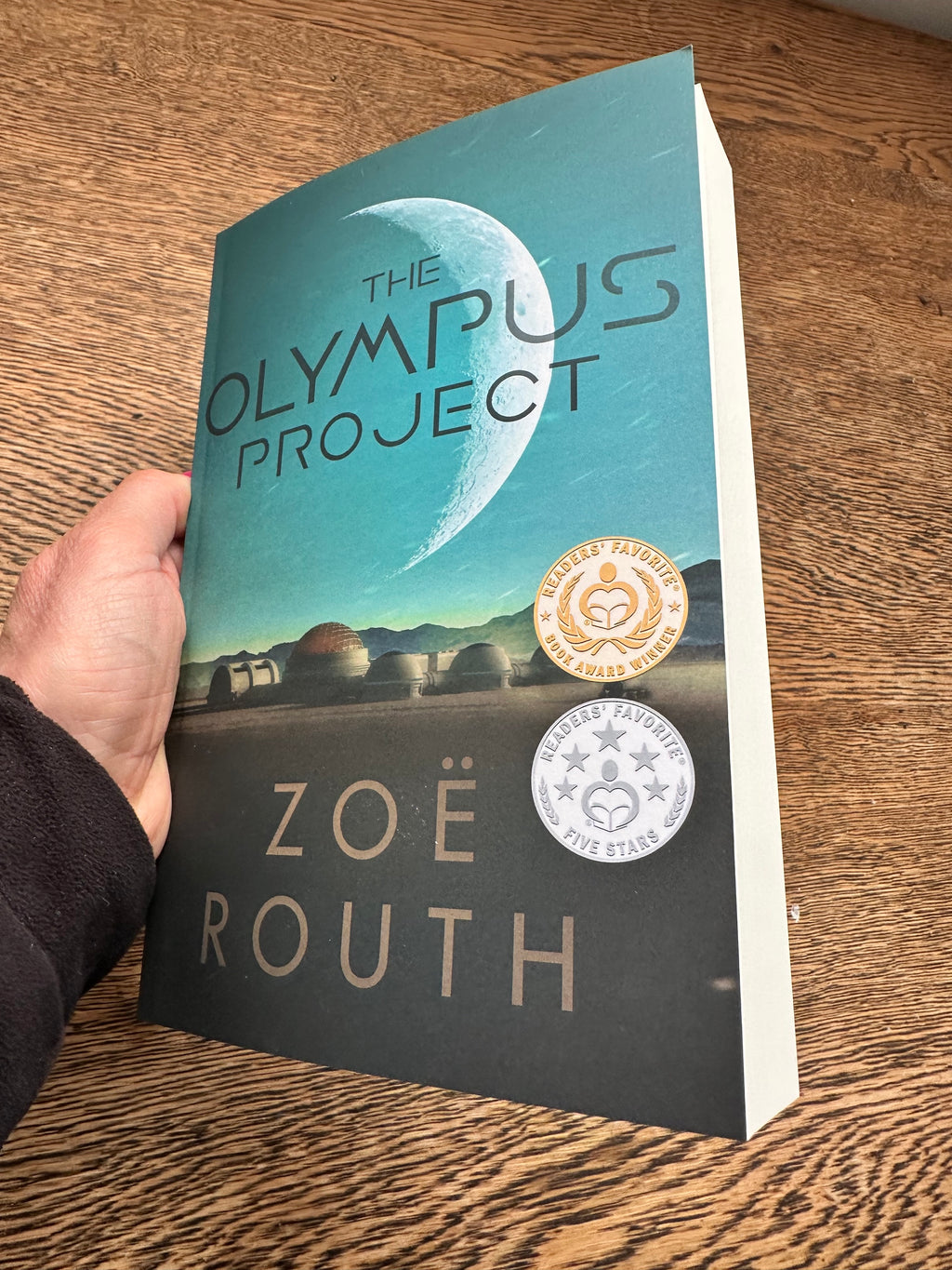 The Olympus Project paperback in hand
